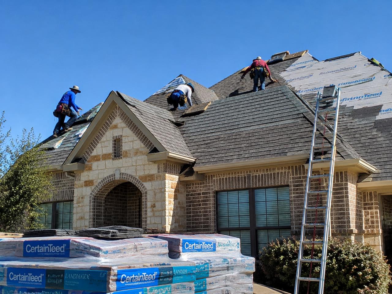 Roofing crew installing shingles on a Texas home